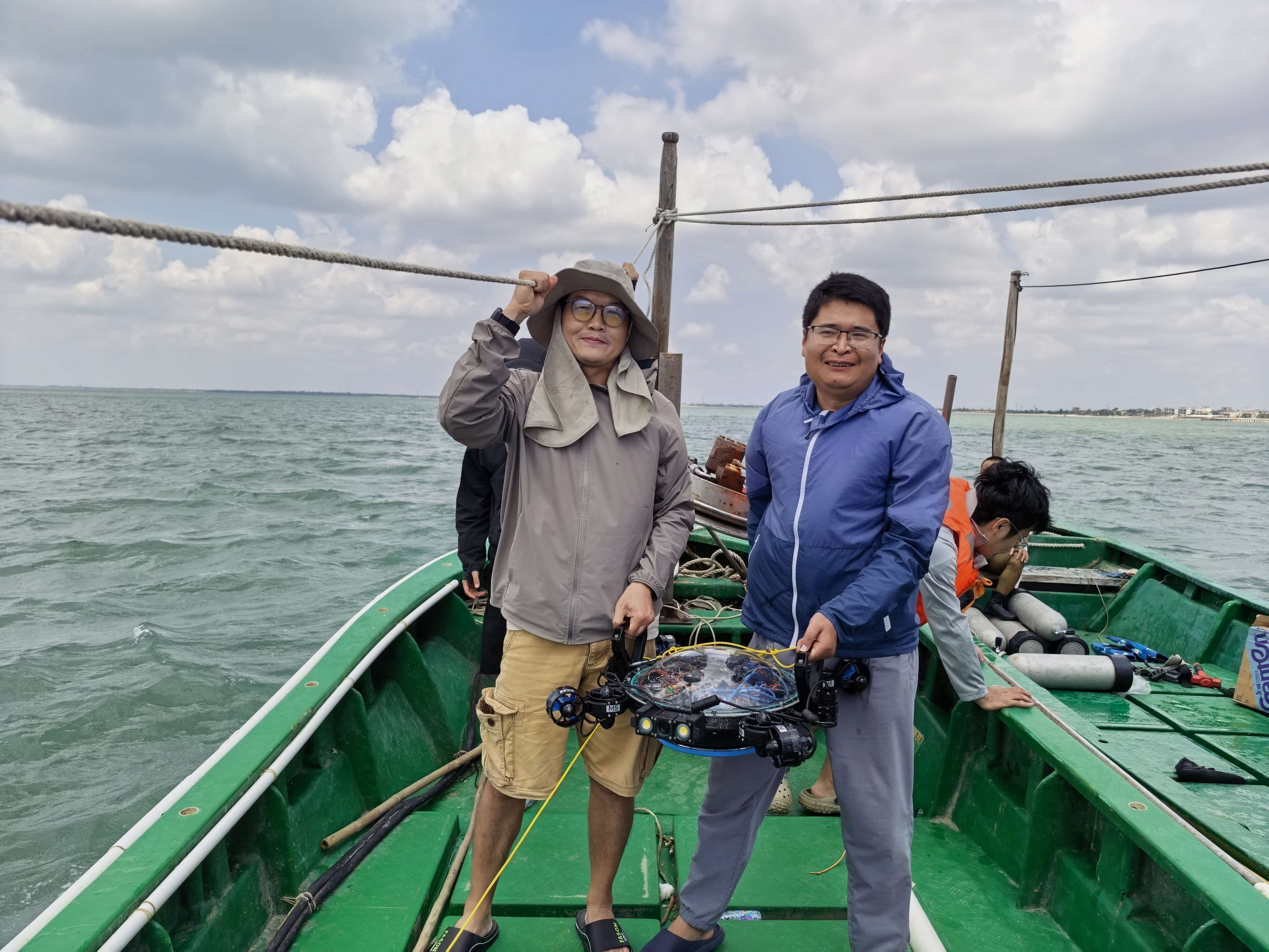 Junfeng and Liyong with an underwater robot